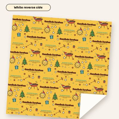 Braai Kersfees wrapping paper with one corner folded back to show the plain white reverse side