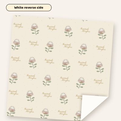 Koningsprotea wrapping paper with one corner folded back to show the plain white reverse side