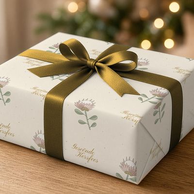 Koningsprotea wrapping paper roll, 30 x 72 in: Single wrapped gift with satin bow on oak, fairy-light bokeh