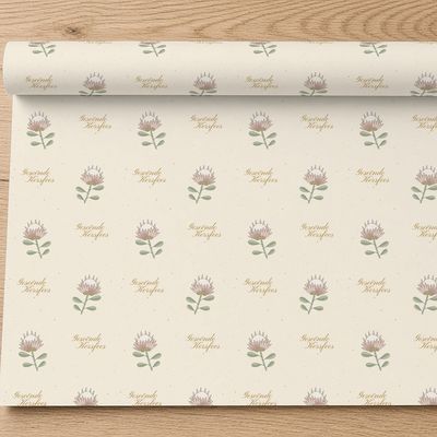 Koningsprotea wrapping paper roll, 30 x 72 in: Roll partly unrolled on light oak (top-down), pattern at true scale for a 30in roll