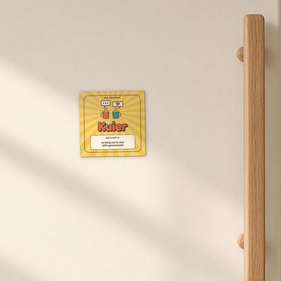 Kuier magnet (Sunshine): Cream enamel fridge door in morning window light, oak handle